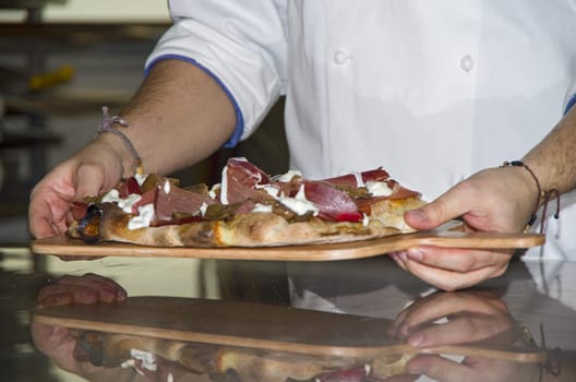 Whites pizzas cooked and stuffed with bacon, artichokes,ham and mozzarella cheese