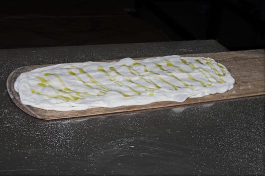 Cooking pizza dough in shovel with electric oven
