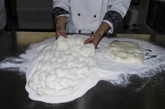 Handling, working and cooking pizza dough with shovel