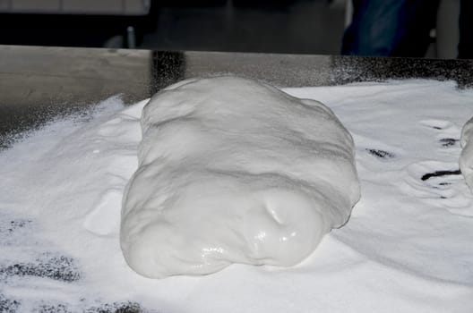 Handling, working and cooking pizza dough with shovel