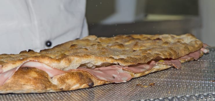 Whites pizzas cooked and stuffed with bacon, artichokes,ham and mozzarella cheese