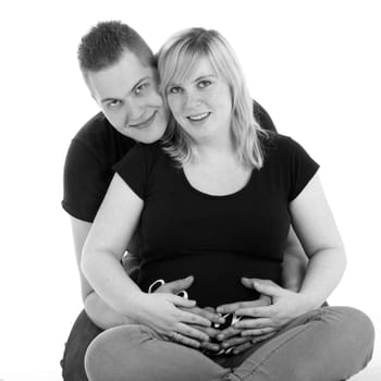 Happy young pregnant couple in the studio