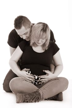 Happy young pregnant couple in the studio