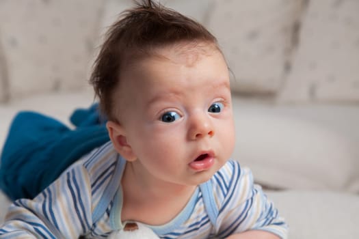 Studio portrait of a 3 months baby boy at home.