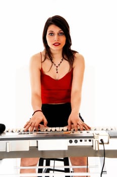 A young brunette woman playing the keyboard for white background..