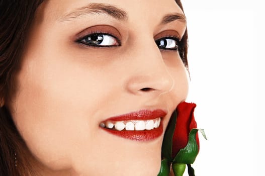 A extreme closeup pictures of the face of a beautiful young woman, holding.a red rose to her face, for white background..