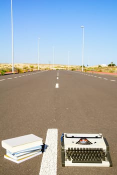 On the Road Writing Concept Typewriter over an Asphalt Street