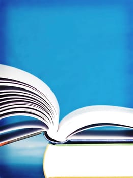 Open book in front of blue background