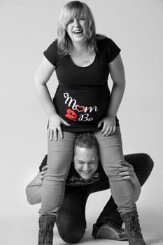 Happy young pregnant couple in the studio