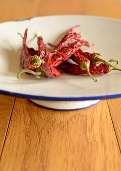Dried chilies on an old used plate