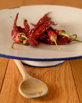 Dried chilies on an old used plate