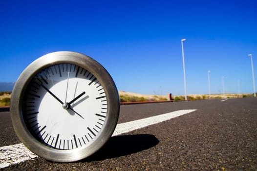 Time Concept Alarm Clock on the Asphalt Street