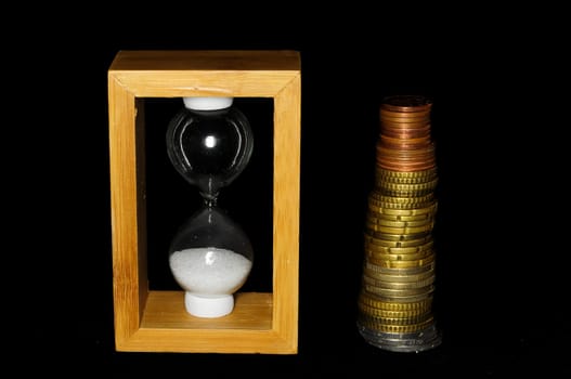 Buisness Time Concept Hourglass and Money on a Black Background