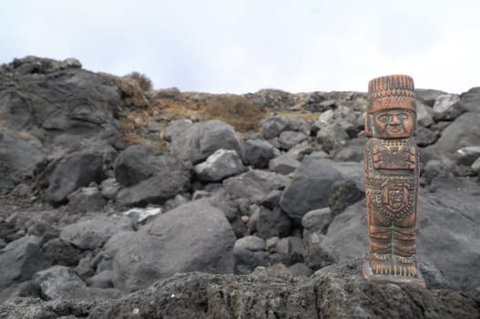 Ancient Maya Statue on the Rocks near Ocean
