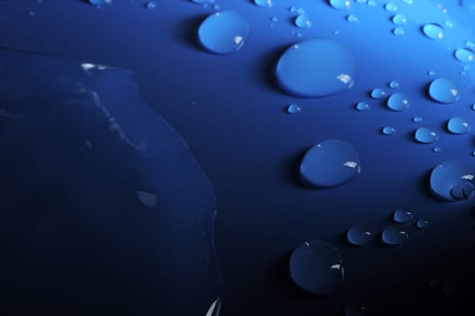 Some Water Drops on a Blue Textured Background