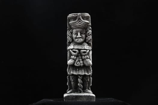 One Ancient Mayan Statue on a Black Background