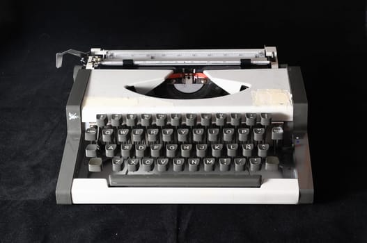An Old Travel Vintage Typewriter on a Black Background