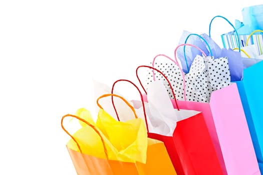 Many colorful shopping bags on white background