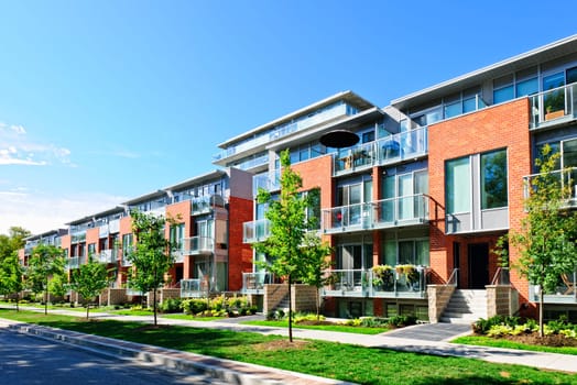 Modern town houses of brick and glass on urban street