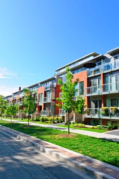 Modern town houses of brick and glass on urban street