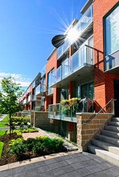 Modern town houses of brick and glass on urban street