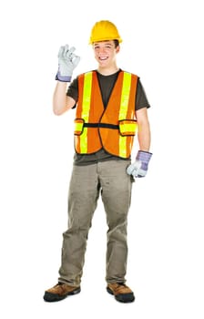 Smiling male construction worker showing okay sign standing isolated on white background