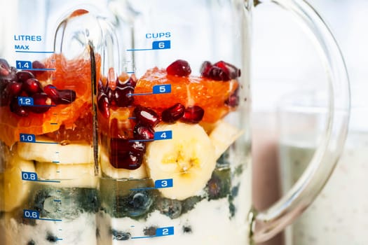 Closeup of healthy smoothie ingredients in blender with fresh fruit