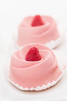 Closeup of two pink raspberry mousse desserts