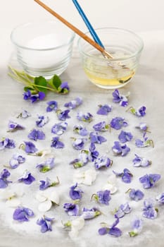 Making candied violet flowers with egg whites and sugar