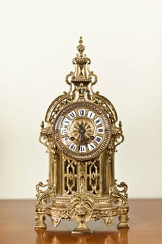 Antique bronze shelf clock with ornate decoration