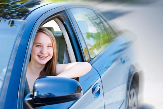Teenage female driving student learning to drive a car