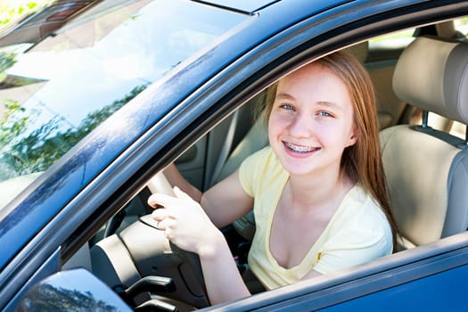 Teenage female driving student learning to drive a car