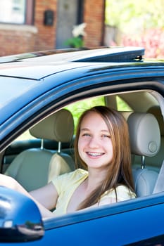 Teenage female driving student learning to drive a car