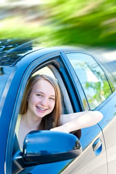 Teenage female driving student learning to drive a car