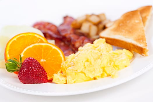 Delicious breakfast of scrambled eggs toast and bacon