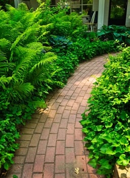 Paved brick path in lush green summer garden
