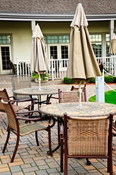 Patio furniture with tables chairs and umbrellas