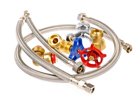 Pile of plumbing valves hoses and assorted parts isolated on white background