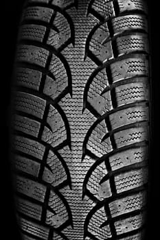 Closeup on rubber tire tread of car wheel