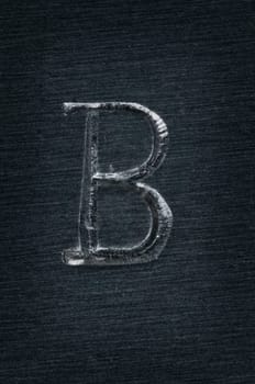Macro image of the letter "B"" in metal"