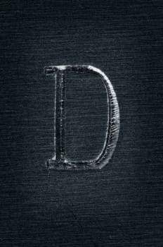 Macro image of the letter "D"" in metal"