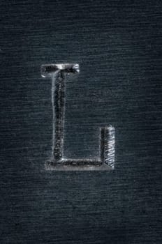 Macro image of the letter "L"" in metal"