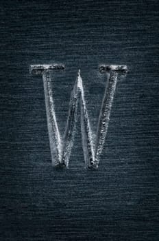 Macro image of the letter "W"" in metal"