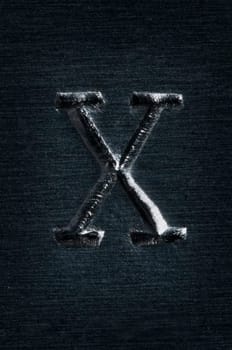 Macro image of the letter "X"" in metal"