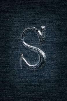Macro image of the letter "S"" in metal"