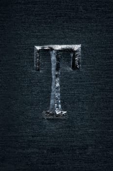 Macro image of the letter "T"" in metal"