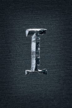 Macro image of the letter "I"" in metal"