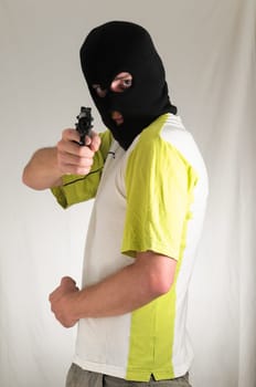White Dressed Young Man Holding a Pistol Gun
