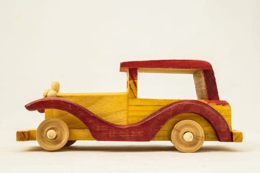 Wooden Toy Red and Yellow Car on a white Backgraund
