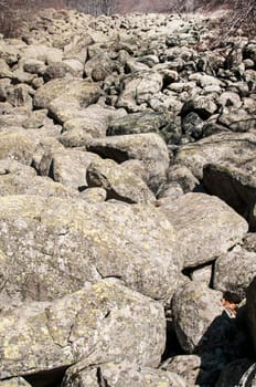 Old moraine rocks with moss in winter sunny day landscape